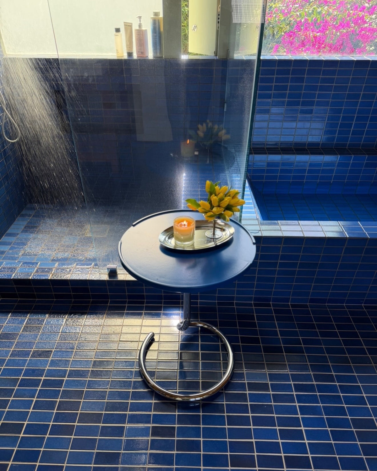 a tv tray in jamie's blue tile bathroom