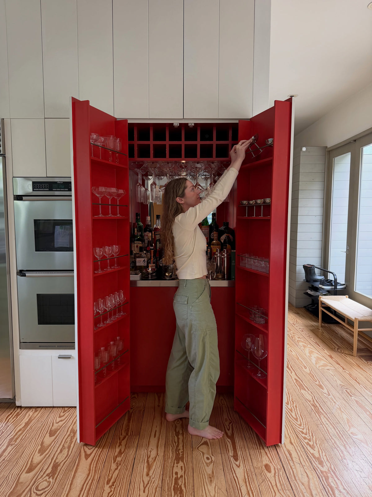 jamie reaching into her red hidden bar