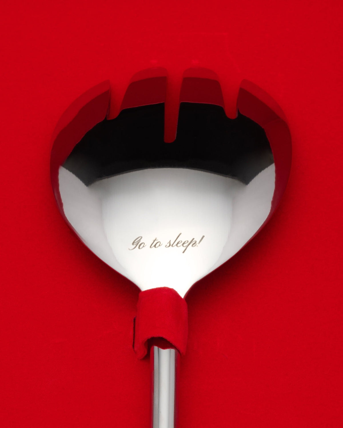 the ladies who lunch serving spoon engraved “go to sleep!”, on red