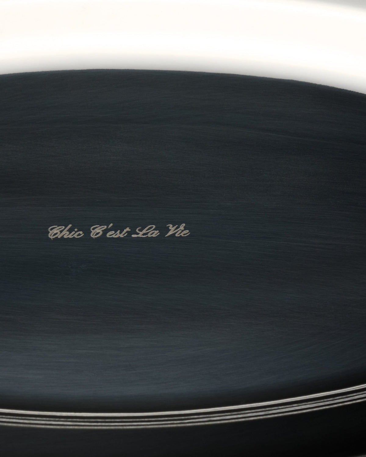 close-up of an oval tray engraved "chic c'est la vie"