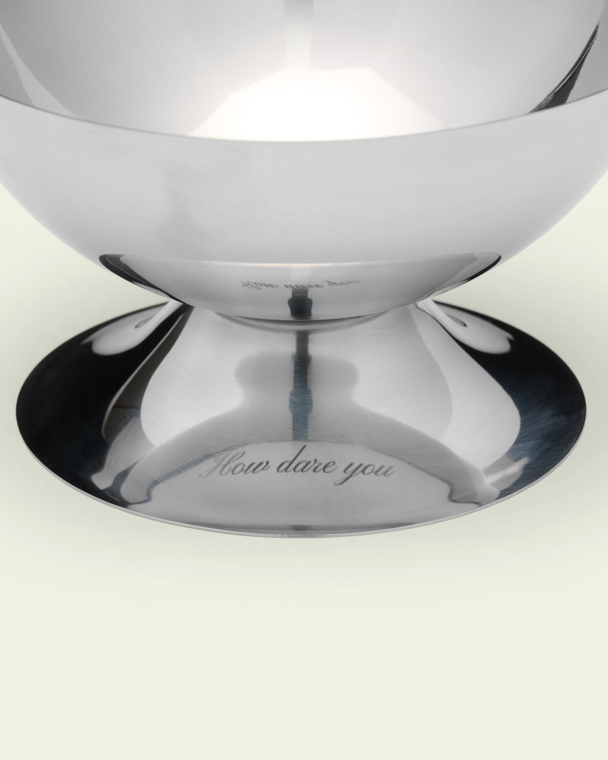 close-up of a snack bowl foot engraved "how dare you", on cream